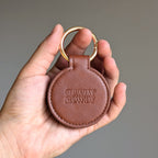 Brown leather keychain with 'Gettin' Rowdy' branding