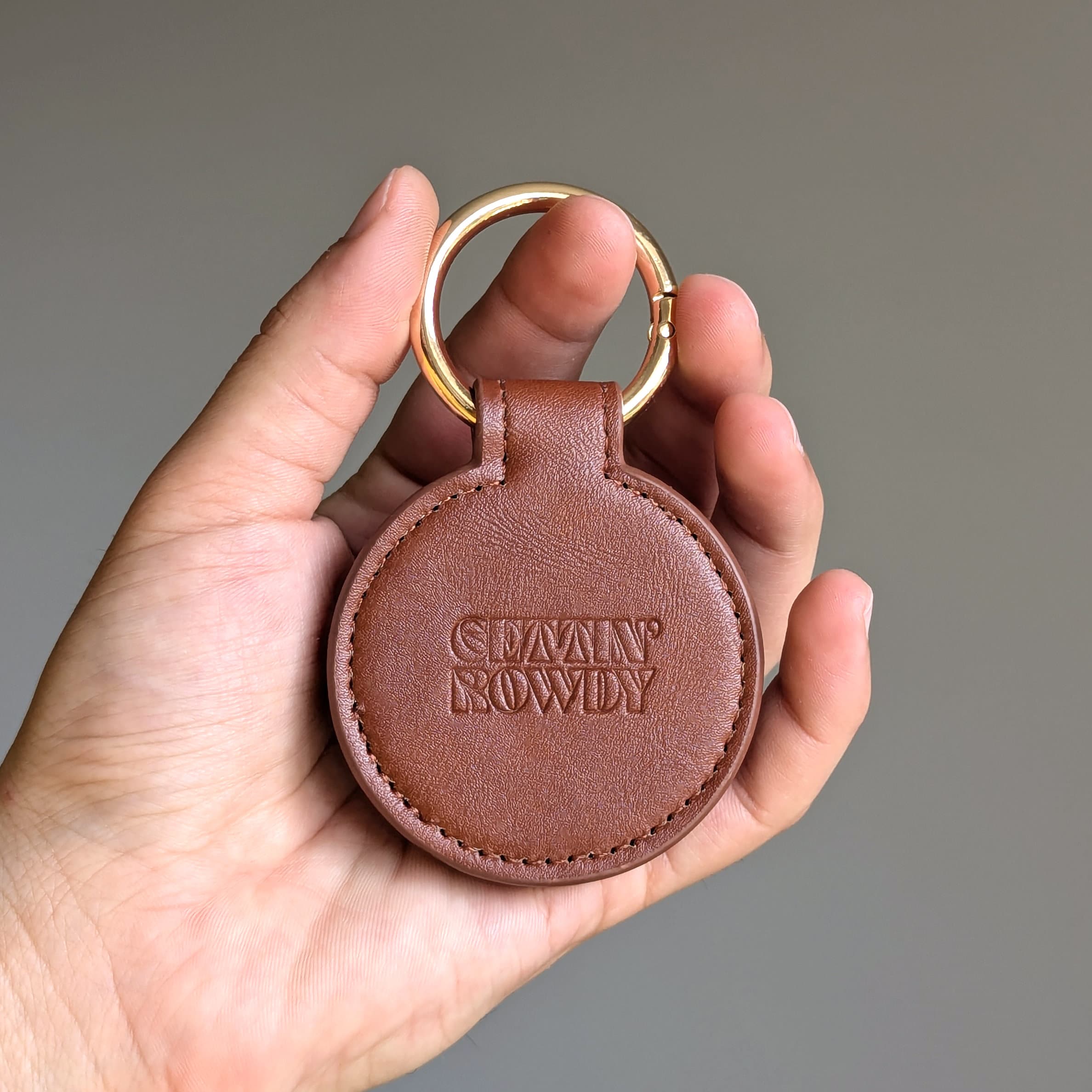Brown leather keychain with 'Gettin' Rowdy' branding