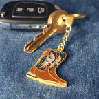 Keychain with a boot design on a keyring against a denim background