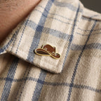 Cowboy hat enamel pin badge on a western shirt