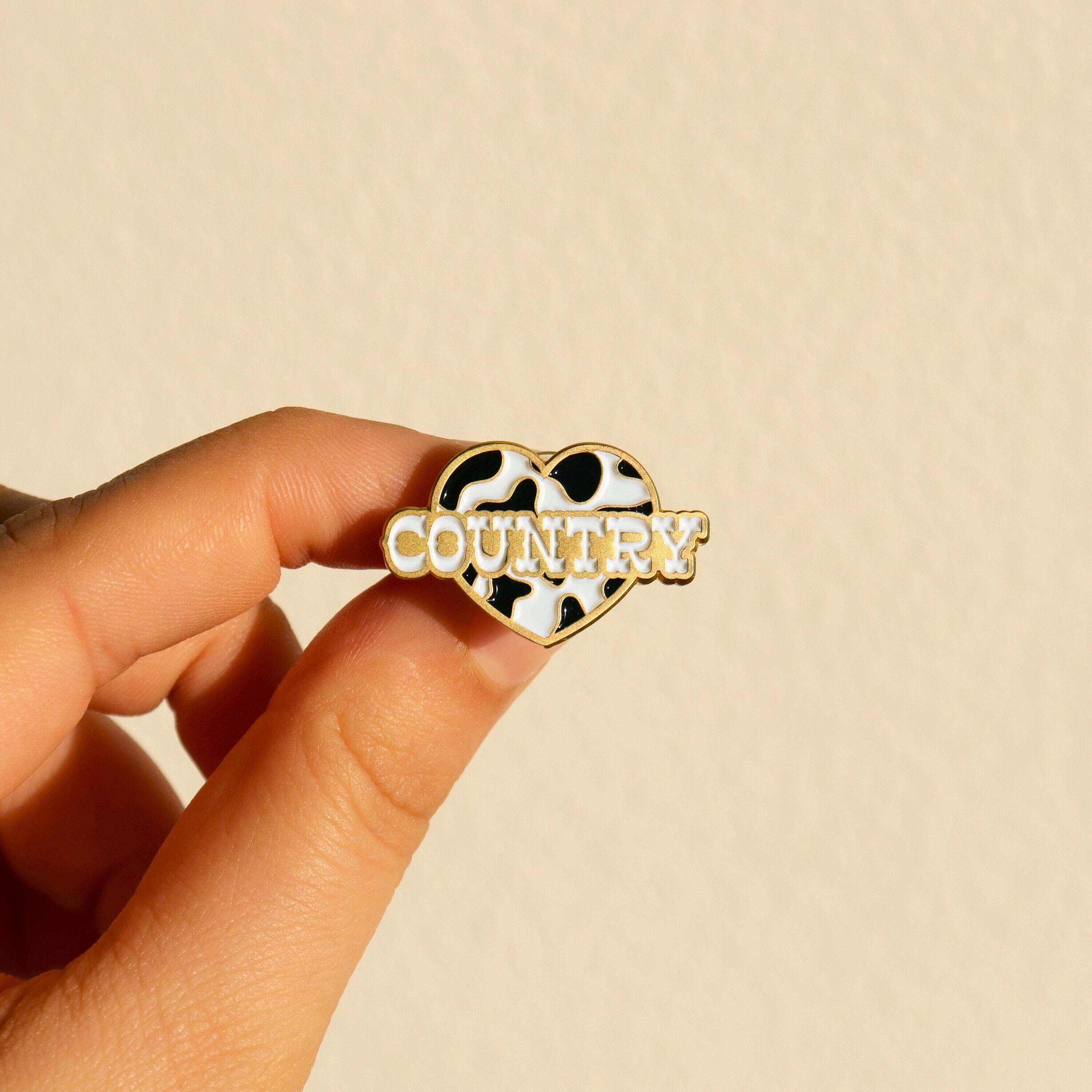 Heart-shaped pin with 'COUNTRY' text 