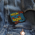 Colorful patch with text and a cowboy boot on a denim jacket