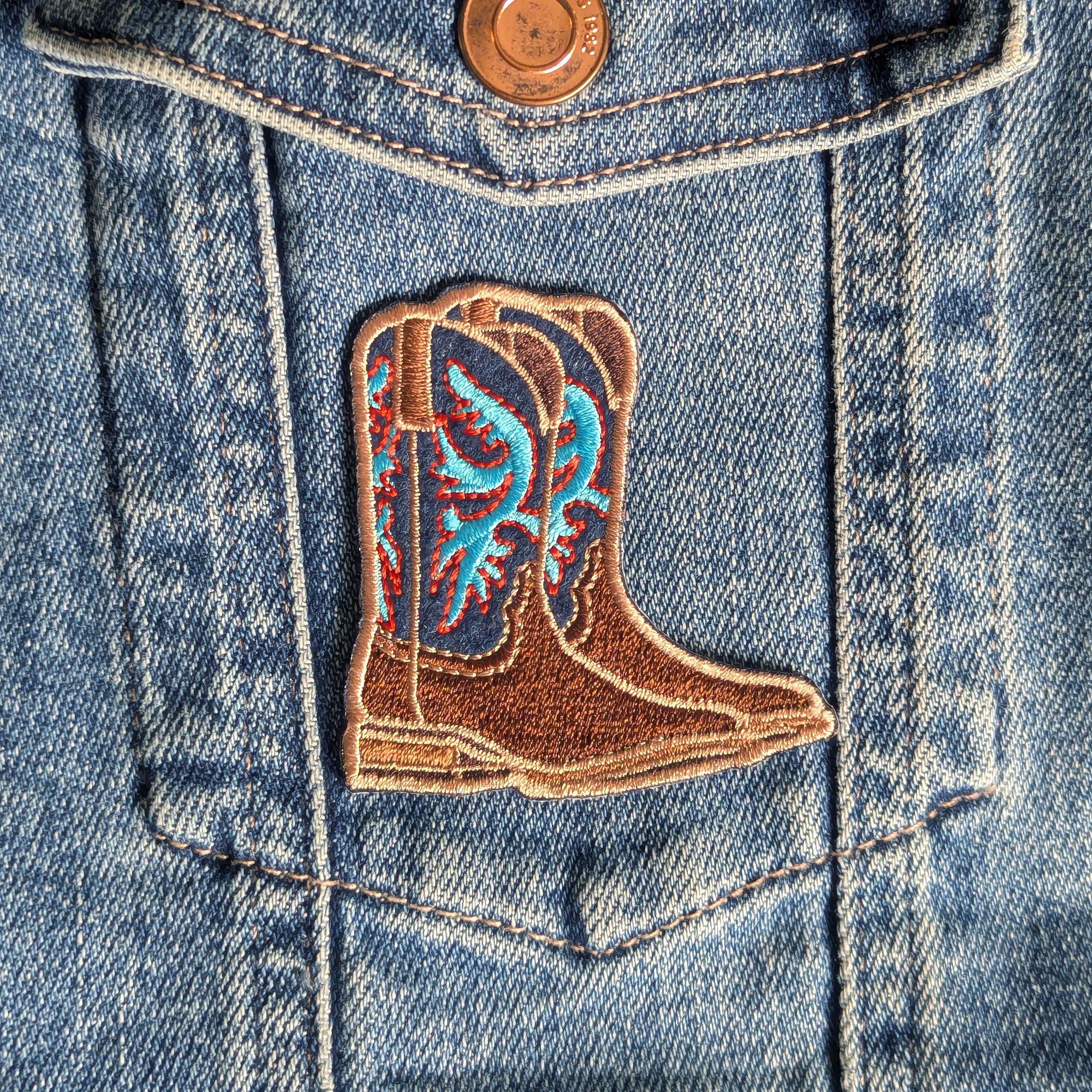 Cowboy boot patch on a denim jacket
