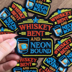 Collection of 'Whiskey Bent and Neon Bound' patches with a hand holding one.