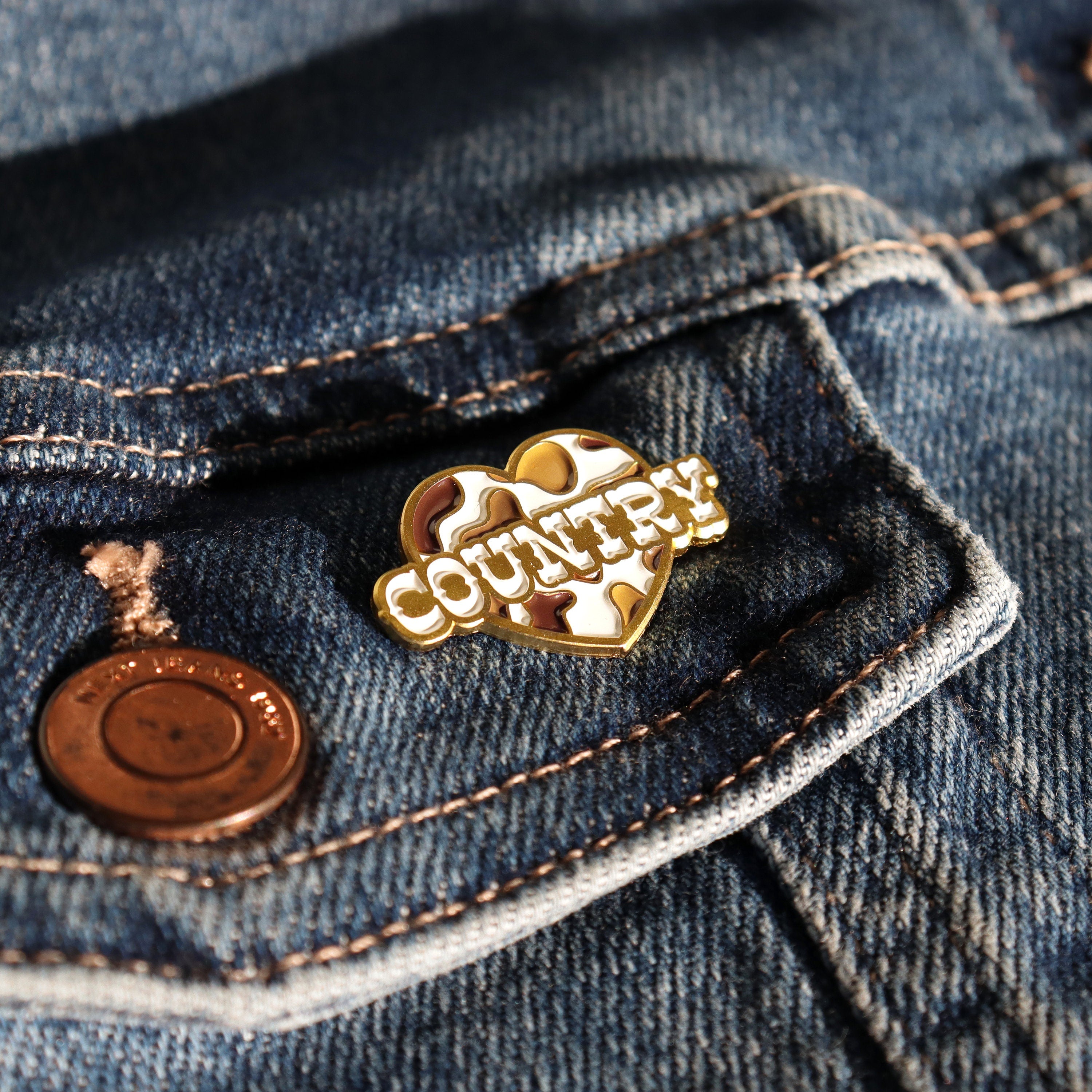 Brown and white cow print heart enamel pin badge for cowgirls