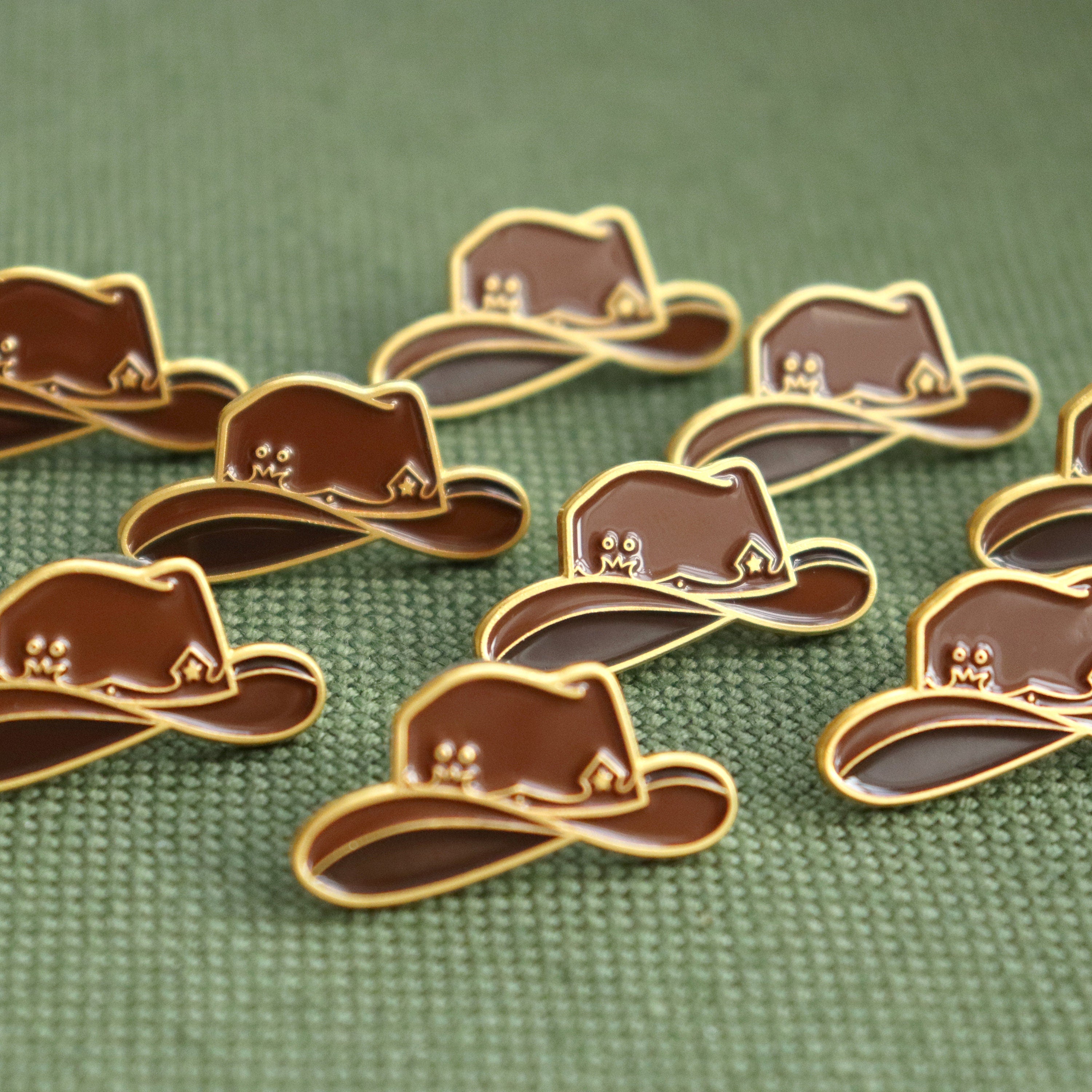 Collection of brown hat-shaped pins